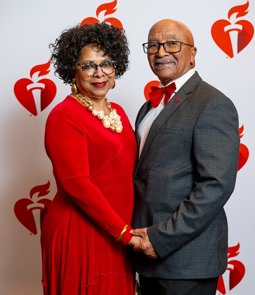 Couple in front of heart and torch banner